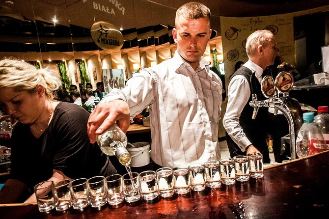 Evening Warsaw - pub and history tour with hotel pickup - Nowy Świat and the Pavilions: vodka shot one in a student-built party zone